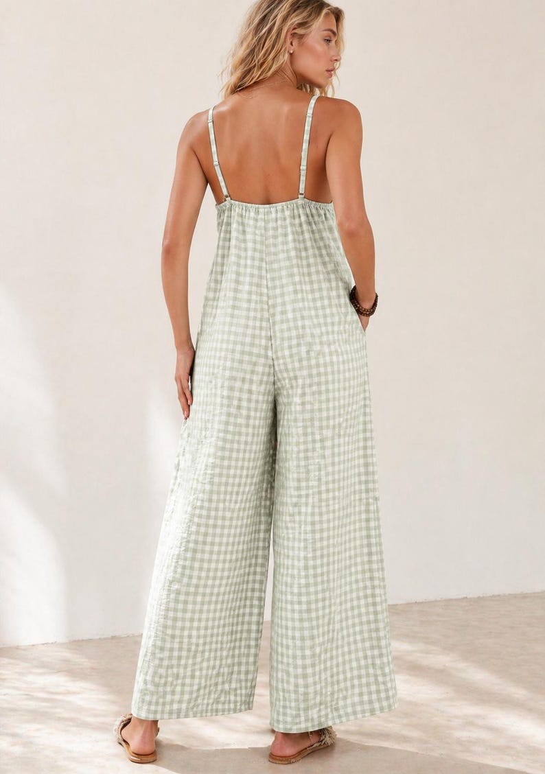 May include: A light green and white gingham jumpsuit with wide legs and thin straps. The backless design features a gathered bodice and pockets. The casual one-piece outfit is suitable for warm weather.
