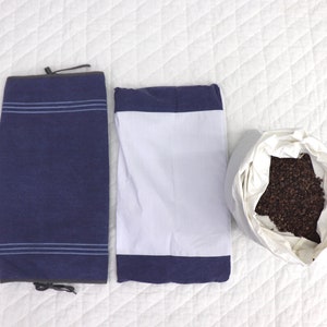 May include: Three pillowcases, one blue with white stripes, one white with a blue border, and one white with buckwheat hulls inside.