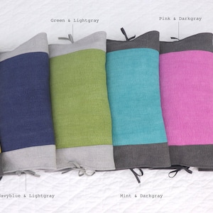 May include: Six decorative throw pillows with two-toned fabric. The pillows are arranged in a row from left to right: yellow and dark gray, navy blue and light gray, green and light gray, mint and dark gray, pink and dark gray, and light gray and dark gray.