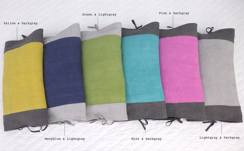 May include: Six decorative throw pillows with two-toned fabric. The pillows are arranged in a row from left to right: yellow and dark gray, navy blue and light gray, green and light gray, mint and dark gray, pink and dark gray, and light gray and dark gray.