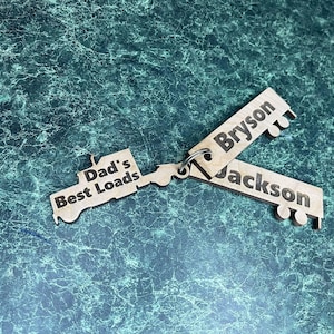 May include: Wooden truck keychains with the text "Dad's Best Loads" and the names "Bryson" and "Jackson".
