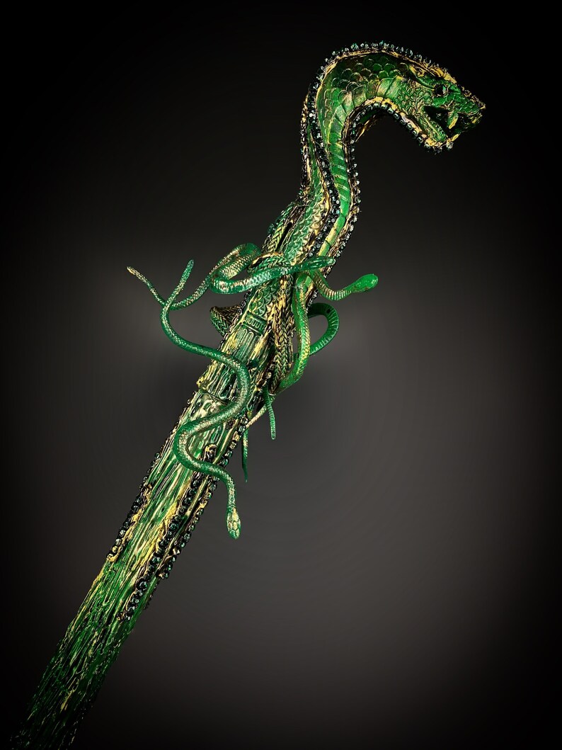 May include: A green snake-shaped walking stick with a detailed, textured surface and gold accents. The snake's head is raised and has a menacing expression.