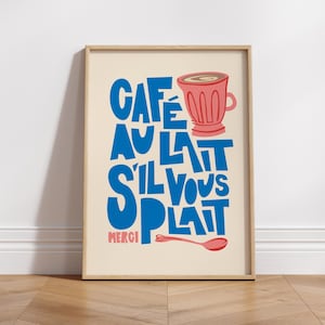 May include: A framed print with a cream background and blue text that reads "Cafe au Lait S'il Vous Plait Merci" with a pink illustration of a coffee cup and spoon.