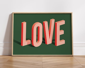 May include: A framed print with the word "LOVE" in bold, 3D-style letters. The letters are a light pink color with red outlines. The background is a dark green color.