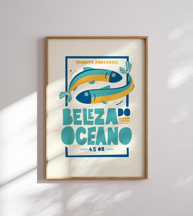 Almanac Co Prints white poster featuring two colorful fish with the text 'Beleza do Oceano' in bold lettering, Portuguese style. Framed in modern kitchen.