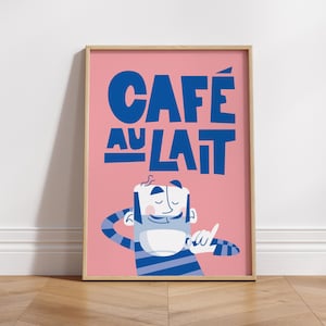 Almanac Co Prints framed 'Café au Lait' poster with bold blue text and a cheerful character, set against a pink background for fun kitchen decor. Framed on wooden floor
