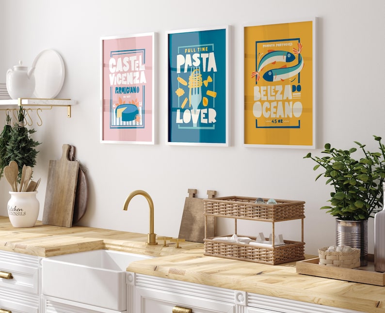Three framed Almanac Co Prints on a wall, featuring vibrant, retro-style designs of cheese, pasta, and fish illustrations.