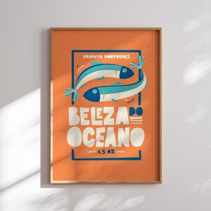 Almanac Co Prints orange poster featuring two colorful fish with the text 'Beleza do Oceano' in bold lettering, Portuguese style.
