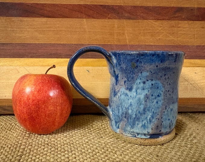 Ceramic wheel thrown mug glazed in a blue and cream glaze. 10-12 oz