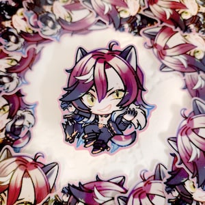 May include: A collection of stickers featuring a cartoon character with purple and white hair, cat ears, and yellow eyes. The character is wearing a dark outfit and holding a small wolf. The stickers are arranged in a circular pattern.