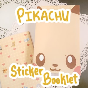 May include: A Pikachu-themed sticker booklet with a light tan cover featuring a Pikachu face design. The words "Pikachu" and "Sticker Booklet" are in yellow. A smaller booklet with a pattern of hearts and cartoon characters is also visible.
