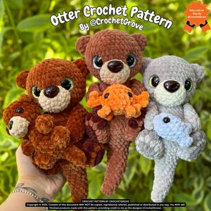 May include: Three crocheted otter plushies in shades of brown and gray, each with a light-colored muzzle and large, dark eyes. One otter holds an orange crocheted crab, and another holds a blue crocheted fish. The text "Otter Crochet Pattern" is at the top.