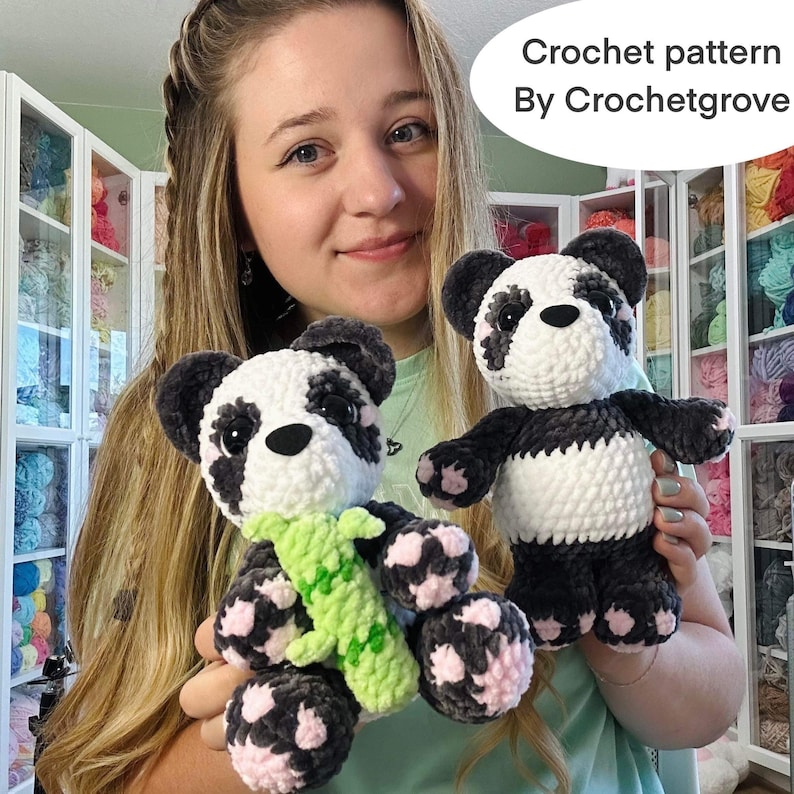 May include: Two crocheted panda bears, one holding a green crocheted bamboo stalk. The panda bears have black and white fur with pink accents. The text "Crochet pattern By Crochetgrove" is visible in the background.