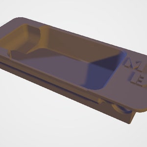 May include: A rectangular, matte gray plastic tray featuring a recessed central compartment with rounded corners and a flat, extended edge on one side. The letters M13 are embossed in a block font on the flat surface of the tray.