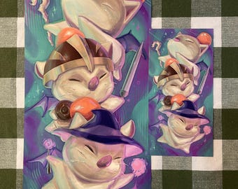 May include: Illustration of several white, cat-like creatures with large eyes, wearing hats and holding various items. The artwork features a purple and teal background with stars and other details. The image is printed on a rectangular piece of paper.