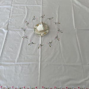 Embroidered vintage tablecloth with flowers.