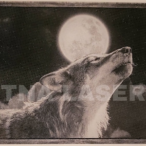 May include: A black and white image of a wolf howling at the moon. The wolf is in the foreground and the moon is in the background. The image is engraved on a wooden plaque.