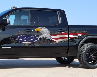 May include: A black pickup truck with a large American flag and bald eagle decal on the side. The decal is designed to look like the flag is ripped and the eagle is flying out of the rip.