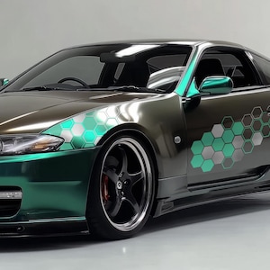 May include: A teal green sports car with black accents and a geometric honeycomb pattern decal on the side. The car has a black front bumper and black wheels.