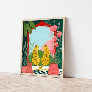 May include: A framed illustration of two yellow leopards with black spots sitting on a checkered floor. The leopards are facing each other and looking out a window with a red archway. The window is framed by green plants and pink flowers.