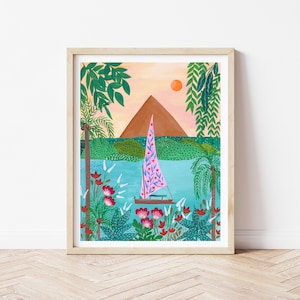 May include: A framed illustration of a sailboat with a pink and blue sail on a turquoise body of water. The sailboat is surrounded by lush green foliage and red flowers. A brown mountain is in the background with a bright orange sun in the sky.