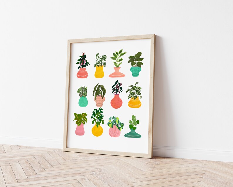 May include: A framed print with a white background featuring a collection of 12 potted plants in various colors and styles. The plants are drawn in a whimsical style with bold colors and patterns.