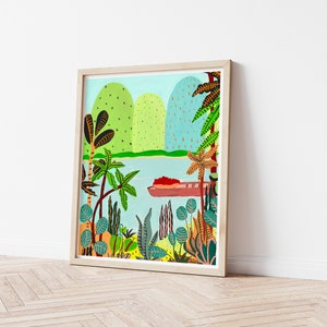 May include: A framed art print depicting a tropical landscape with a boat on the water. The artwork features green hills, palm trees, and various plants in vibrant colors. The frame is made of light-colored wood.