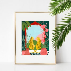 May include: A framed illustration of two leopards sitting back to back in front of a colorful archway with pink flowers and green plants. The leopards are facing each other and the archway is open to a blue sky with pink clouds.