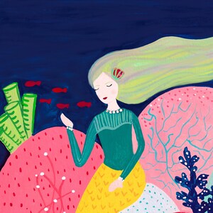 May include: A mermaid with long blonde hair sits on a pink coral reef. She is wearing a green shirt and a yellow skirt with a white and blue pattern. There are red fish swimming around her.