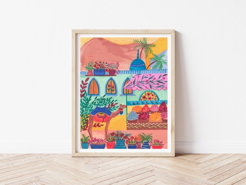 May include: A colorful illustration of a camel standing in front of a building with a pink awning. The building has blue windows and a blue dome on top. There are potted plants and flowers on the roof and in front of the building.