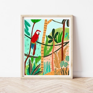 May include: A framed art print featuring a vibrant illustration of a red, blue, and yellow macaw perched on a branch in a lush jungle setting. The artwork includes various green plants, trees, and a light blue sky.