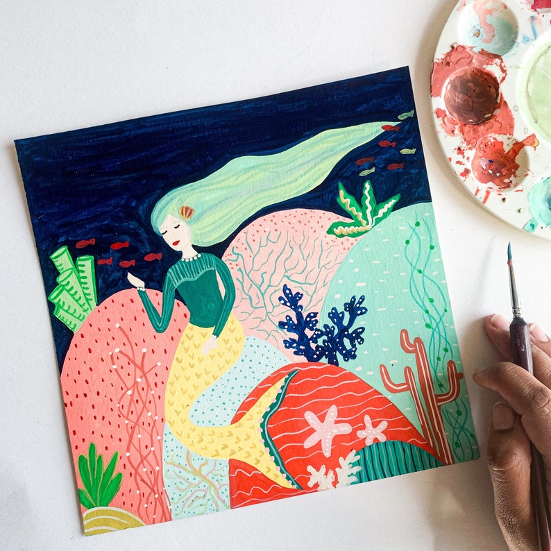 May include: A colorful painting of a mermaid with long green hair and a yellow tail, swimming in a coral reef. The painting features a variety of coral, fish, and other sea life.