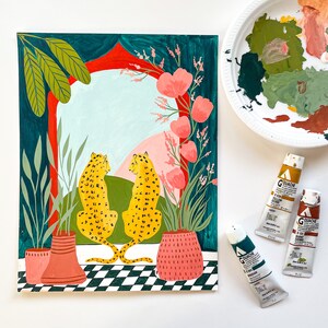 May include: A painting of two leopards sitting back to back in front of a colorful archway. The leopards are facing each other and have a green, pink, and blue background. The archway is decorated with flowers and plants.