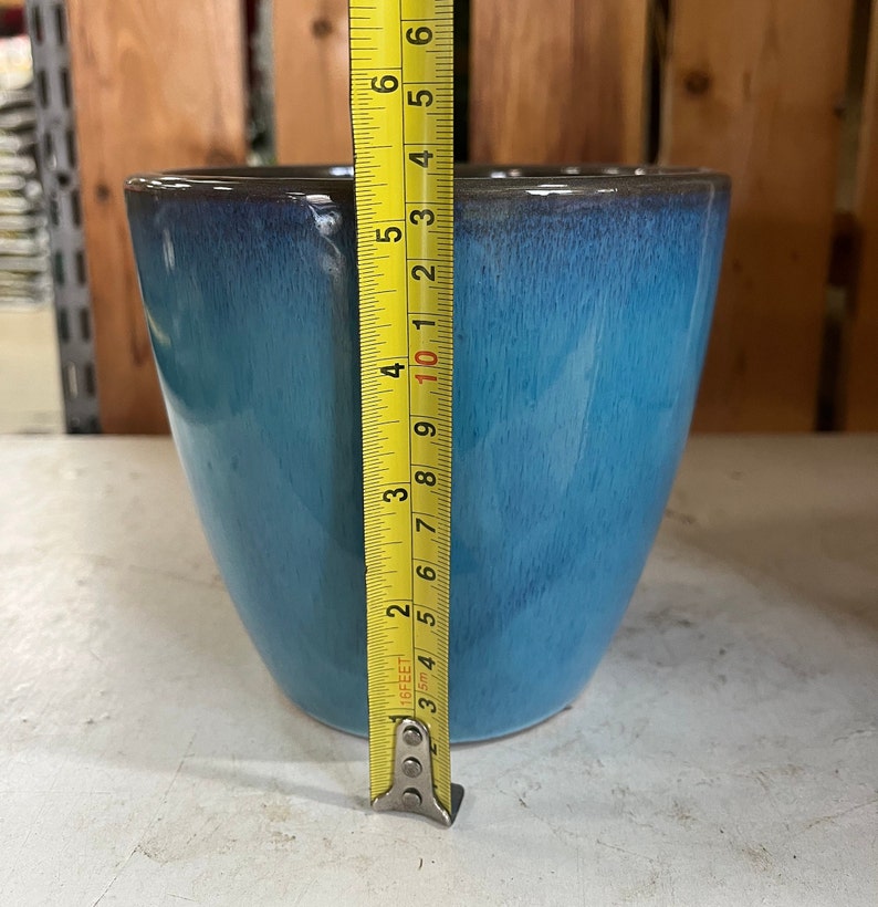 Op de afbeelding: Een blauwe keramische pot met een donkergrijze rand. De pot is 10 cm hoog.