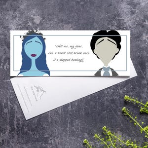 May include: A white card with illustrations of two characters and the text "Tell me, my dear, can a heart still break once it's stopped beating." The card is partially inside a white envelope, set against a textured gray background.
