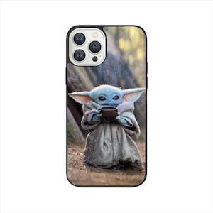 May include: A phone case featuring a green and blue character holding a cup. The character is standing in a woodland setting. The phone case has a black border.