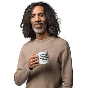 May include: A white coffee mug with a black quote that reads "I am way too sleep deprived to deal with your negativity right now. - John Mulaney". A person is holding the mug in their left hand.