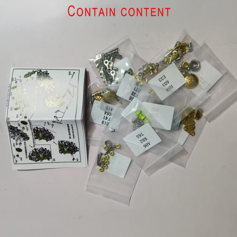 May include: A selection of small metal model kit components, such as screws and pins, presented in clear plastic bags. A folded instruction sheet is visible, with the text "CONTAIN CONTENT".