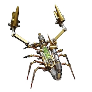 May include: A metal scorpion sculpture with a green liquid level indicator in its body. The scorpion is made of gold, silver, and copper colored metal.