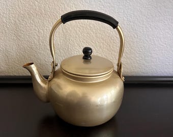 vintage gold-toned aluminum teapot with a black handle mid century modern 5” diameter