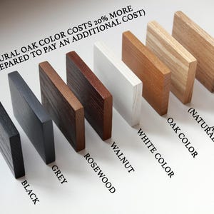 May include: Wood samples in various colors, including black, grey, rosewood, walnut, white, oak, and ash. The text "NATURAL OAK COLOR COSTS 20% MORE (BE PREPARED TO PAY AN ADDITIONAL COST)" is written at the top of the image.