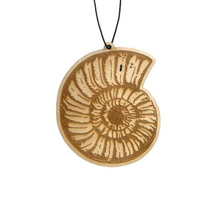 May include: A wooden ornament shaped like an ammonite, a type of extinct marine mollusk. The ornament is brown and has a detailed carving of the ammonite's spiral shell.