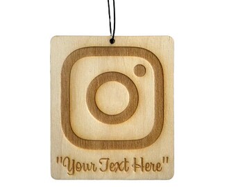 May include: Wooden car air freshener with a laser-engraved Instagram logo and the text "Your Text Here".