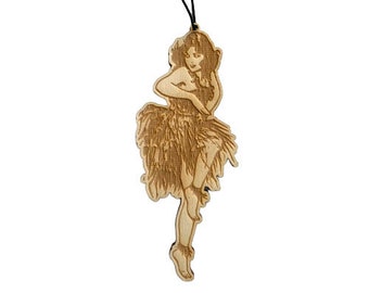 May include: A wooden ornament of a woman in a hula skirt, with a black string for hanging.