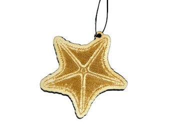 May include: A wooden starfish ornament with a light brown color and a string for hanging.
