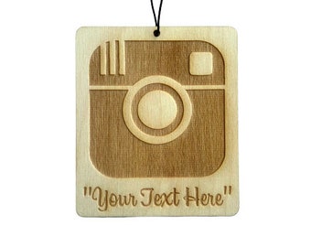 May include: A wooden car air freshener with a laser-engraved Instagram logo and the text "Your Text Here".