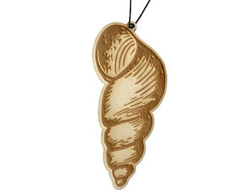 May include: A wooden seashell ornament with a detailed design, hanging from a black string.