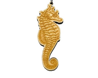 May include: A wooden ornament shaped like a seahorse. The seahorse is detailed with intricate lines and is a light brown color.