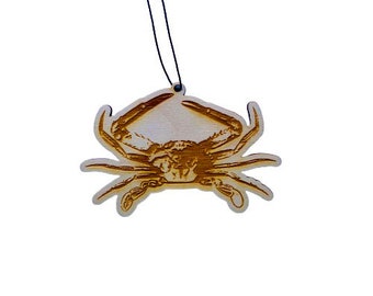 May include: A wooden ornament shaped like a crab with a black string for hanging.