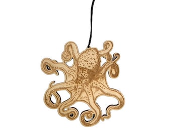 May include: A wooden ornament shaped like an octopus with intricate details. The ornament is hanging from a black string.